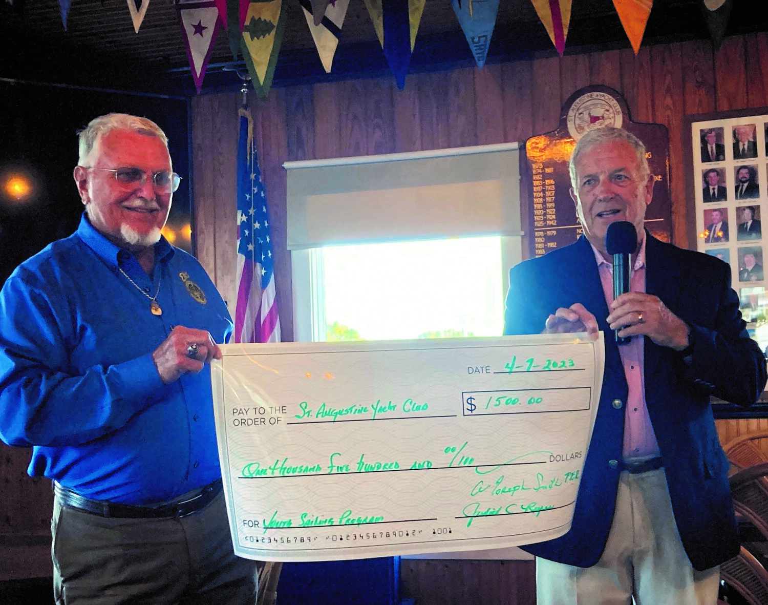 Elks Exalted Ruler Joseph Smith presents a $1,500 check to SAYC Commodore David Patrick for kids to attend Sail Camp.